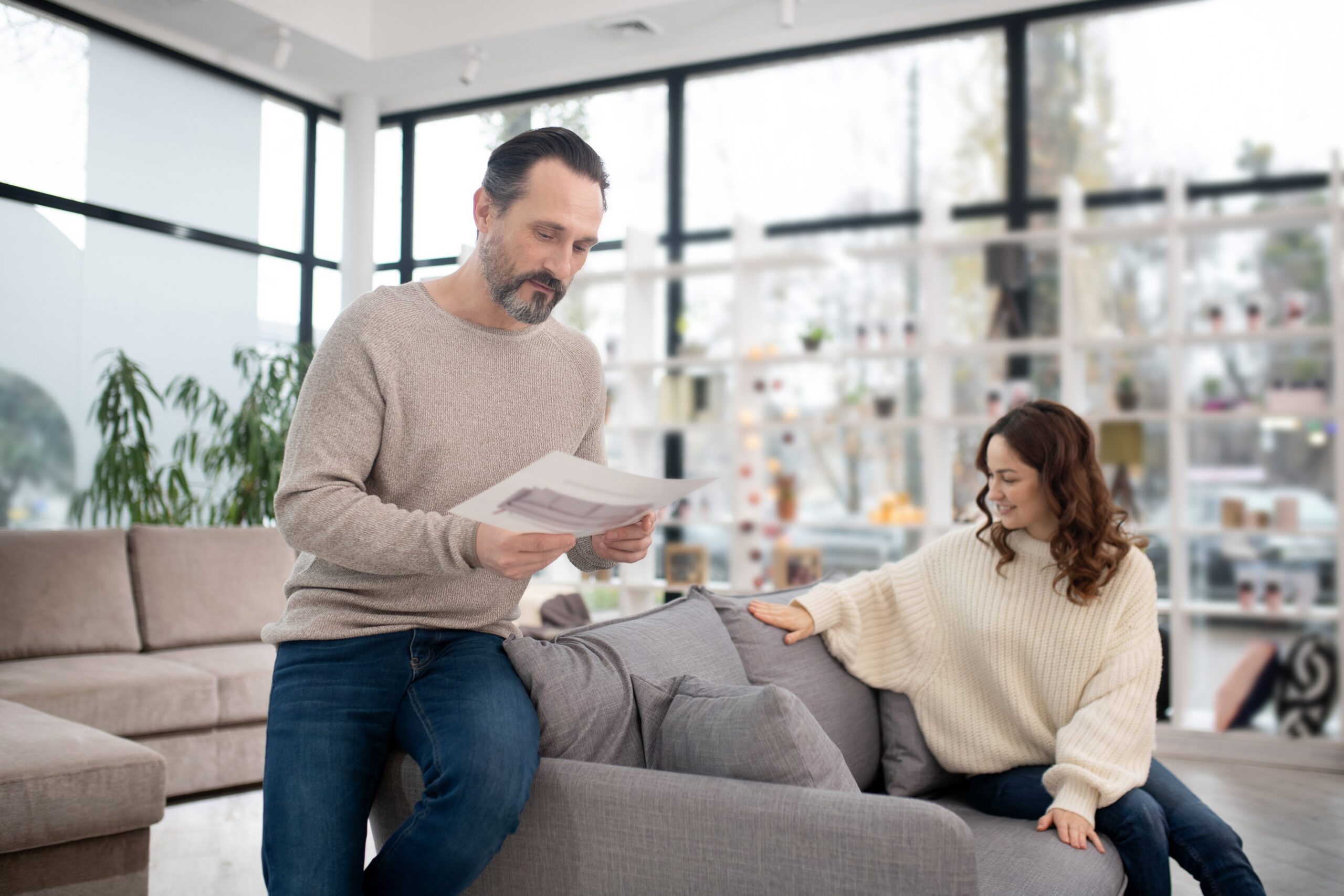 Bearded handsome man looking at the drawing
