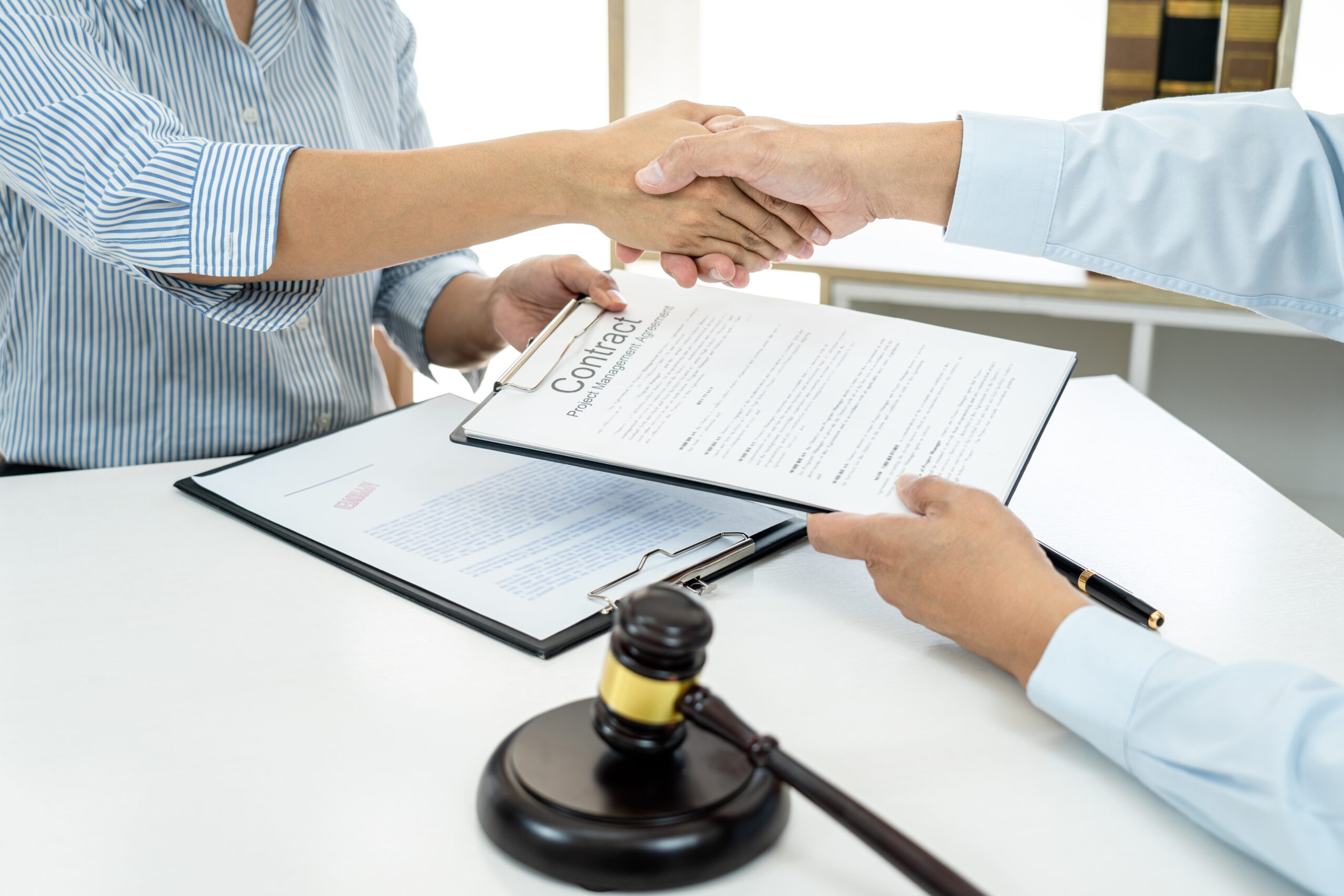 Businesswoman shaking hands with a professional lawyer after discussing a good deal of contract
