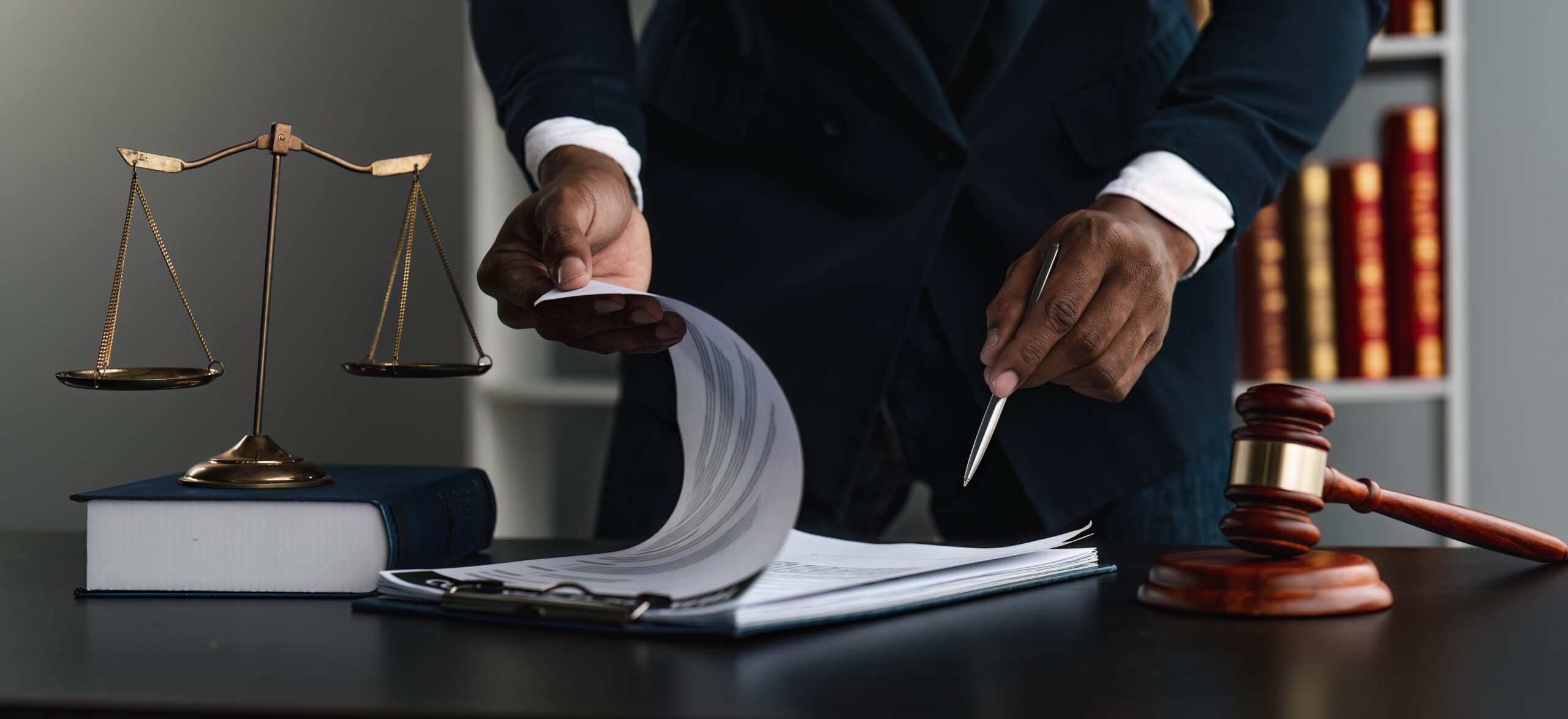 Close up lawyer businessman working or reading lawbook in office workplace for consultant lawyer