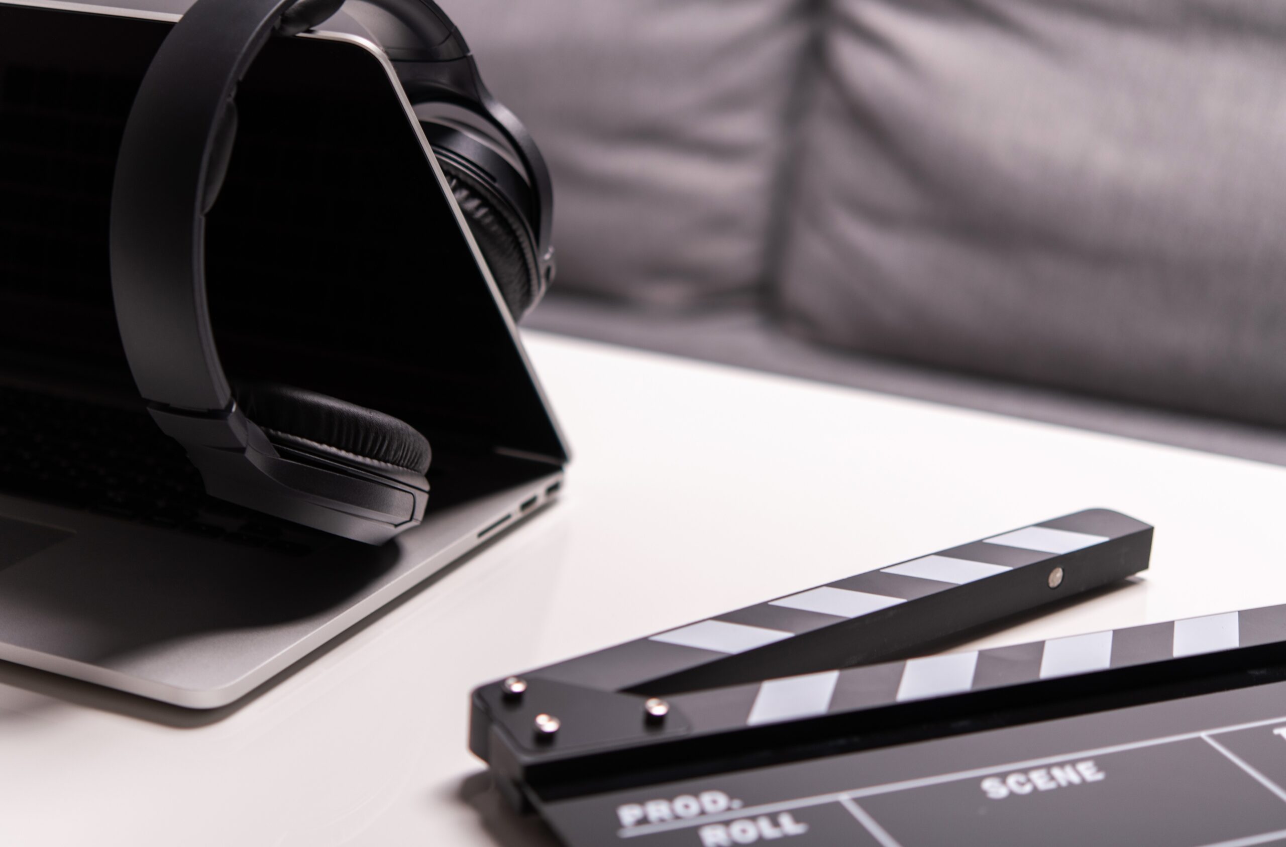 Close Up Of Computer Headphones And Clapperboard.