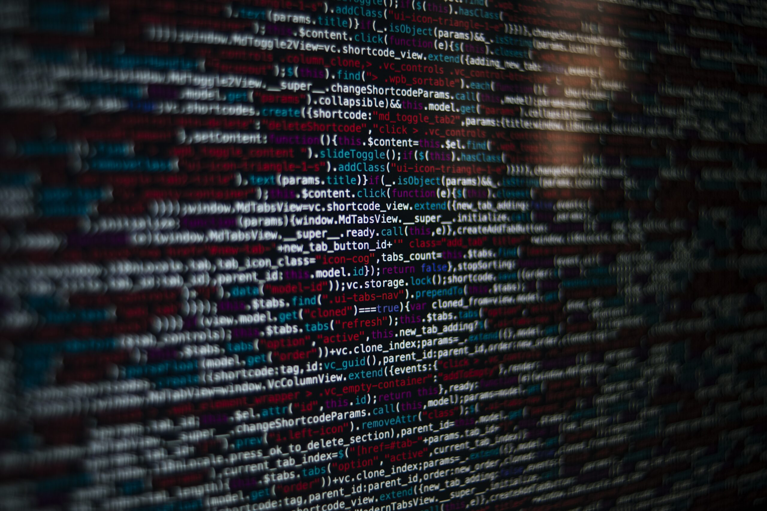 Closeup shot of a screen with HTML JavaScript source code for web page development data