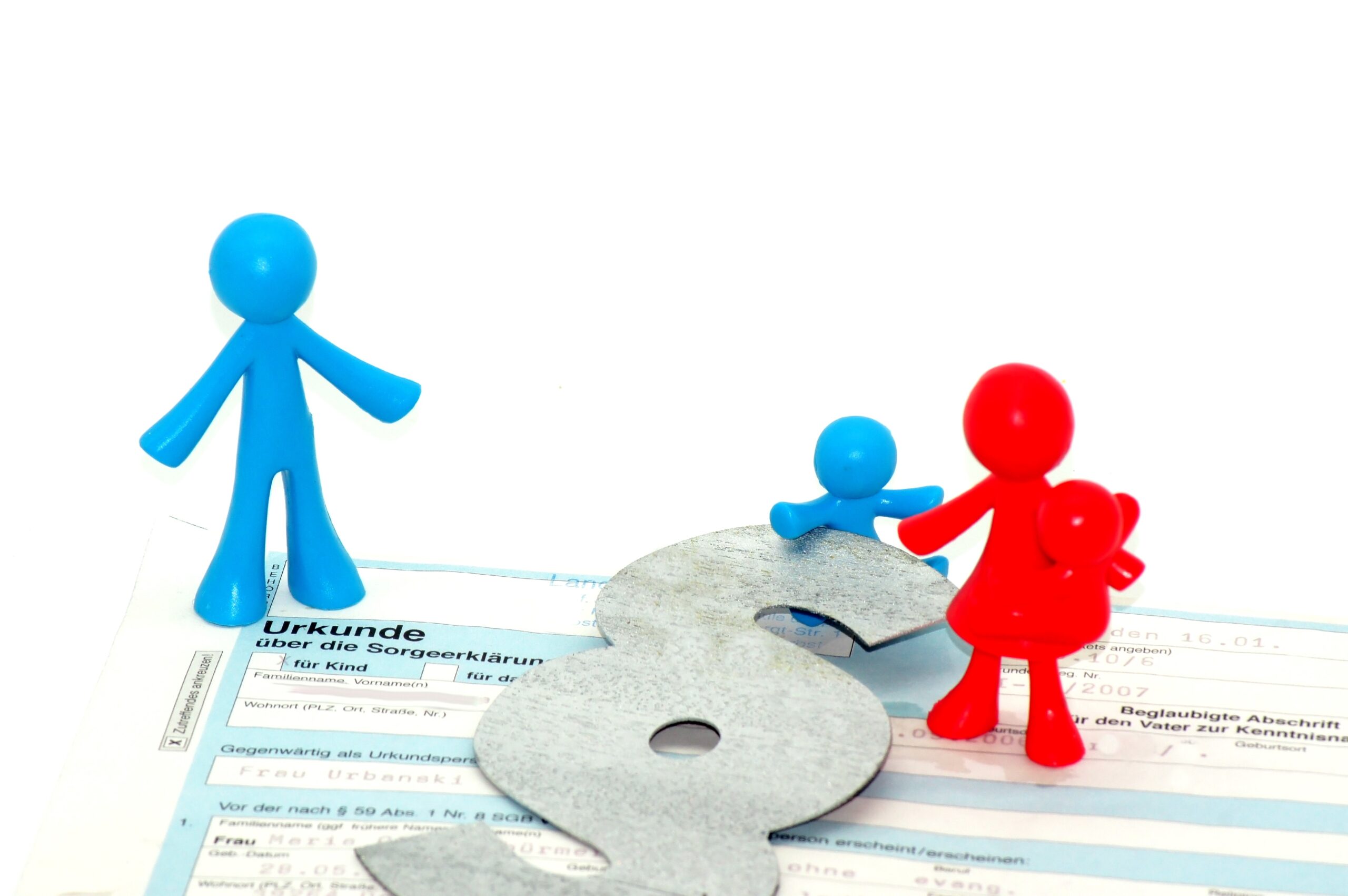 Closeup shot of parental custody figures with a certificate on a white background