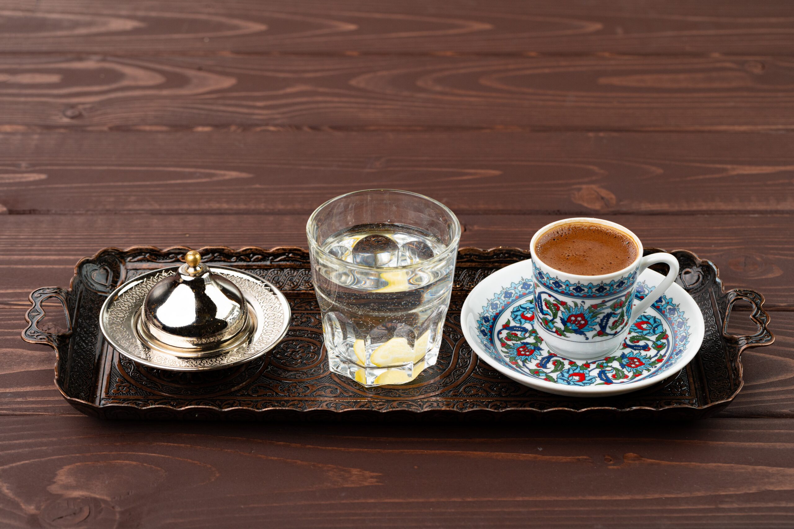 Cup of coffee in oriental style on metal tray