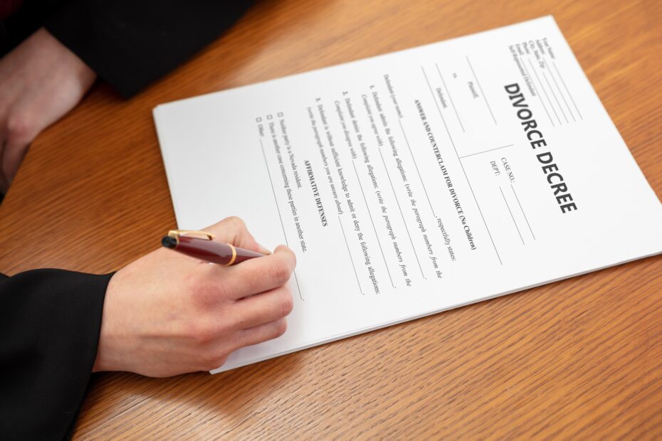DIVORCE DECREE. Woman sign the paper. Lawyer, notary office, close up above view