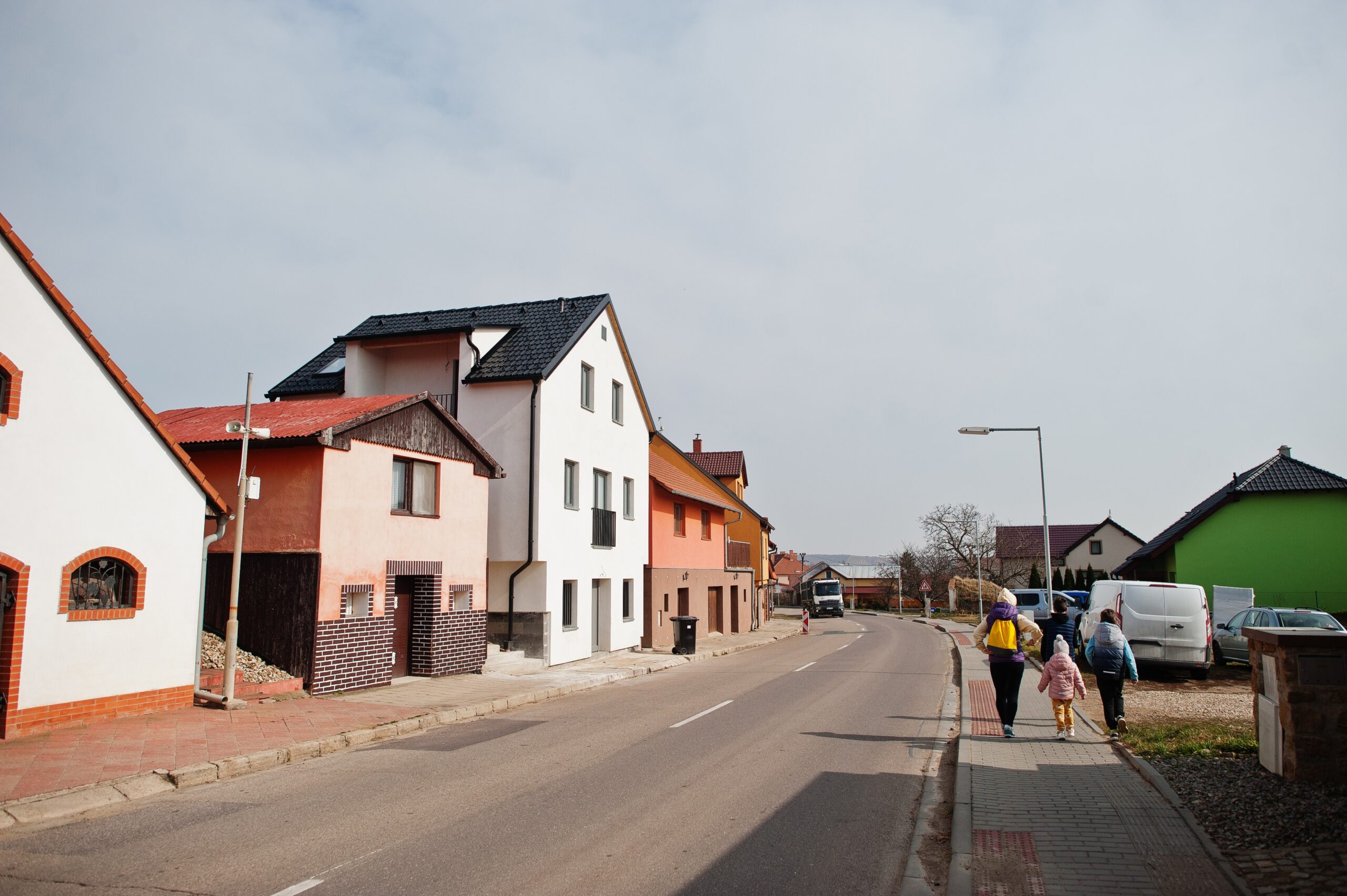 Family walking streets of village in Czech Republik.