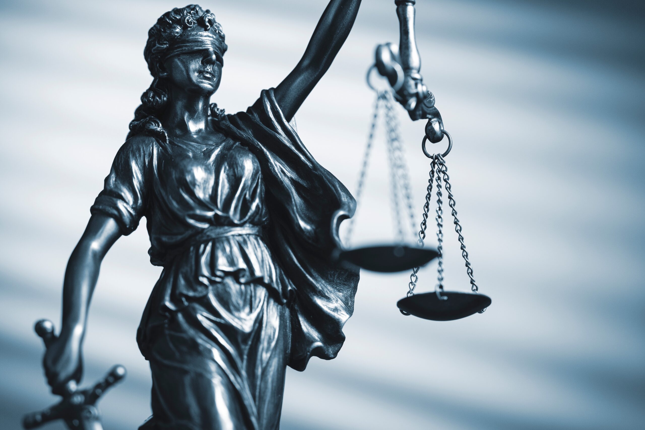 Figure of Justice holding scales and a sword
