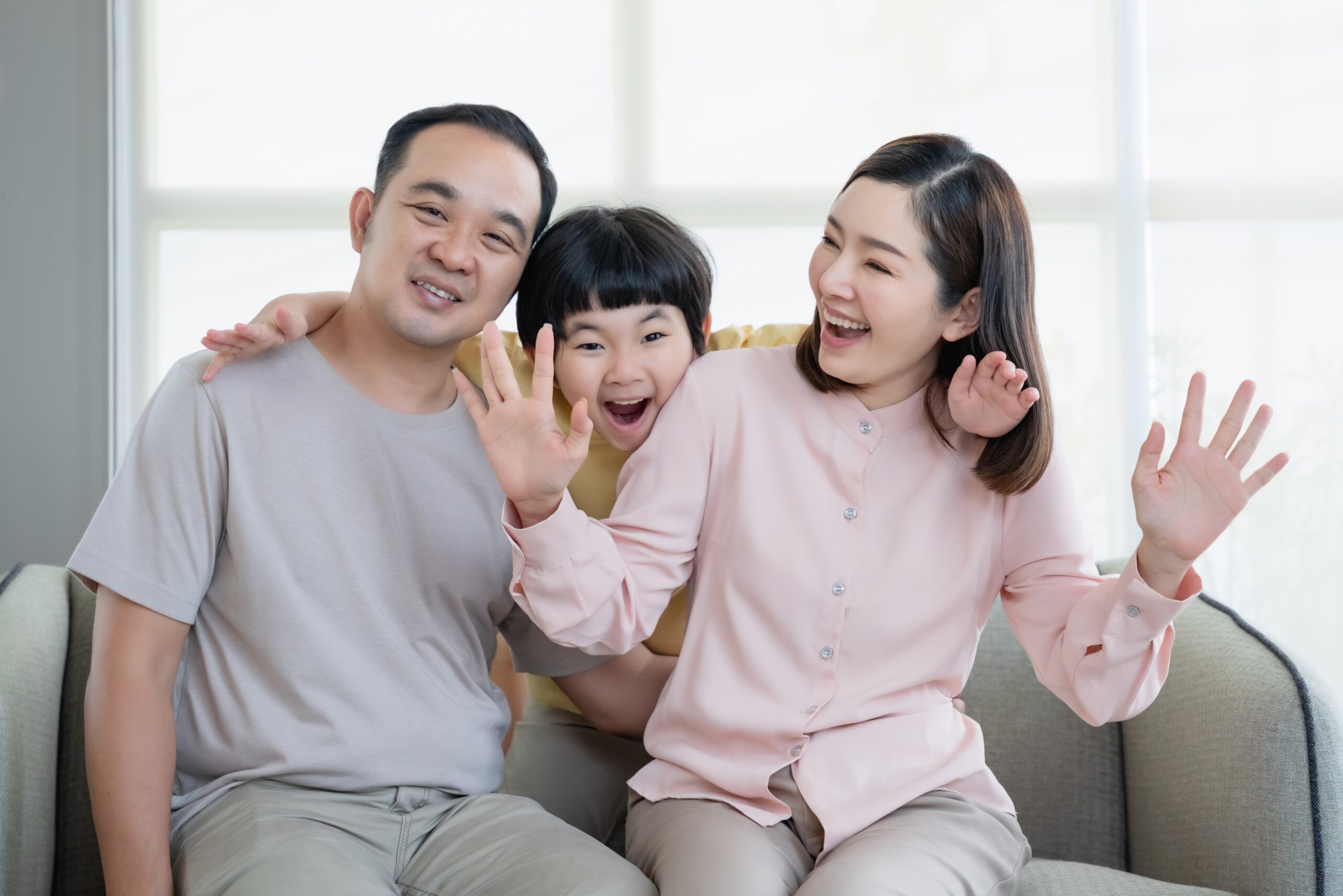 Happy Asian family with son playing at home and everyone having fun together at home.