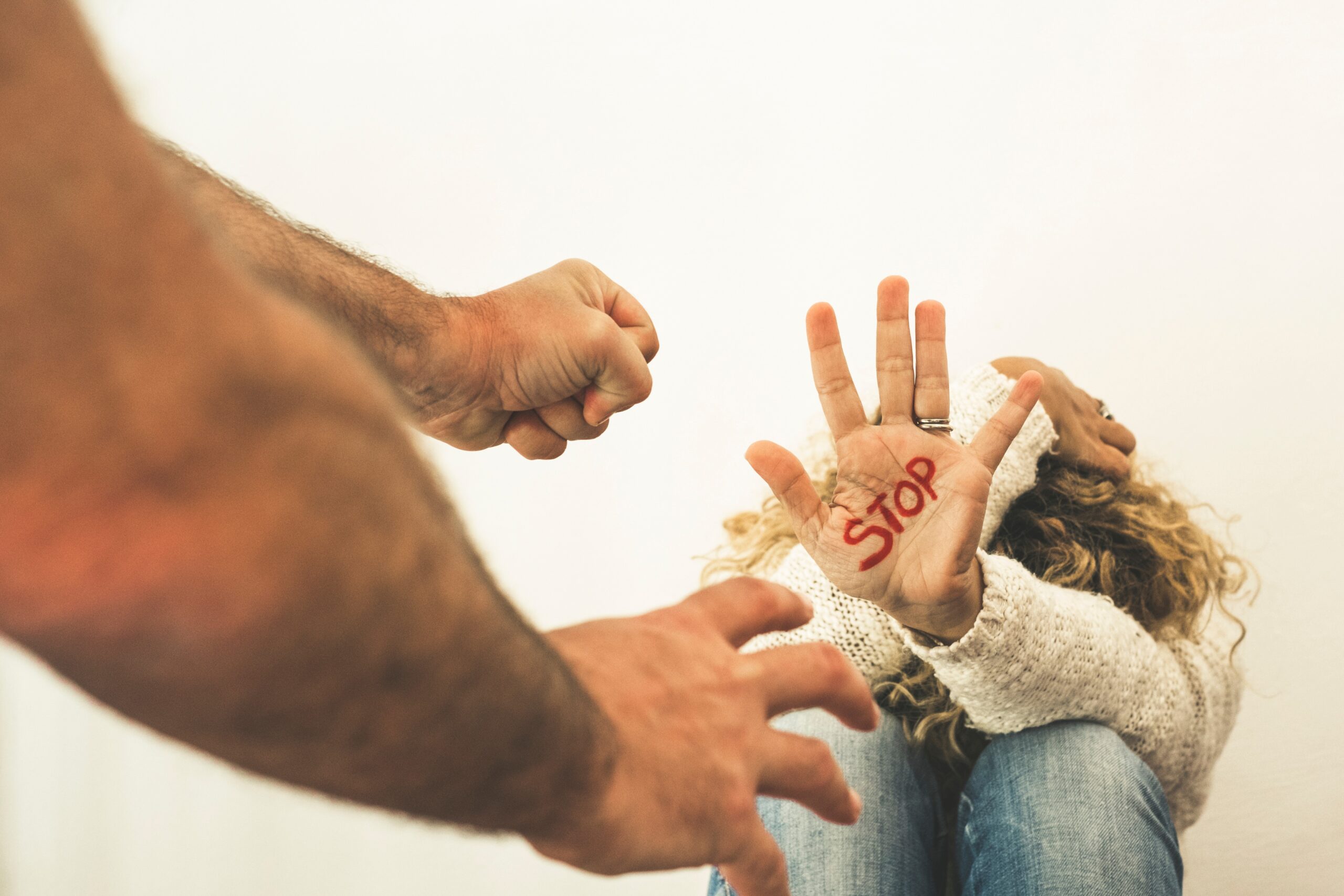Home couple violence abuse concept with woman protect herself sitting on the floor and stop