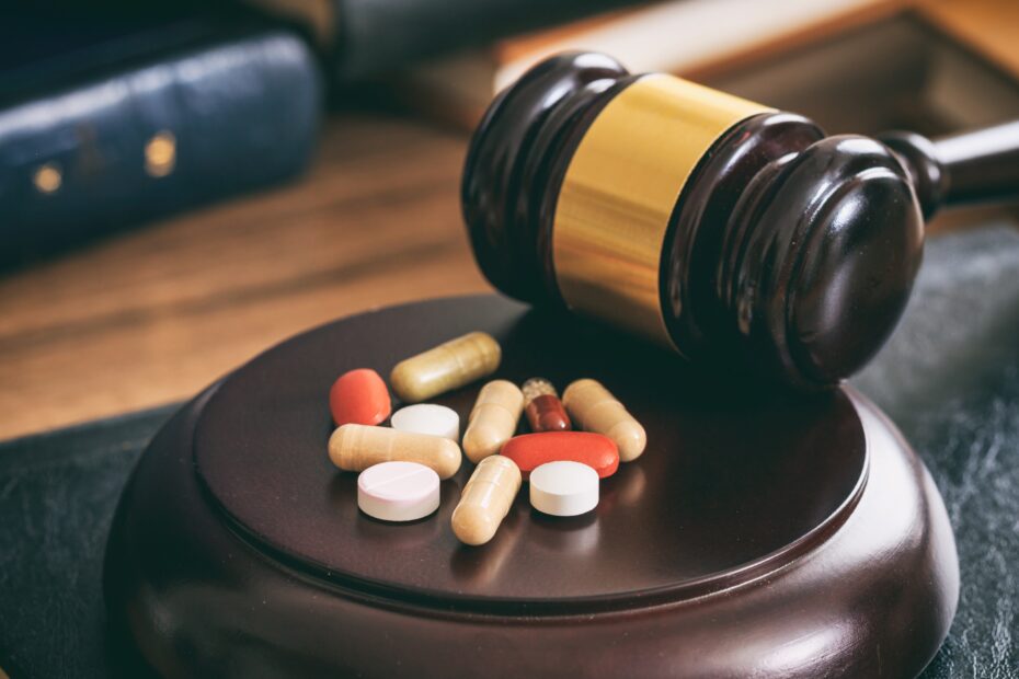 Judge gavel and drugs on a wooden desk