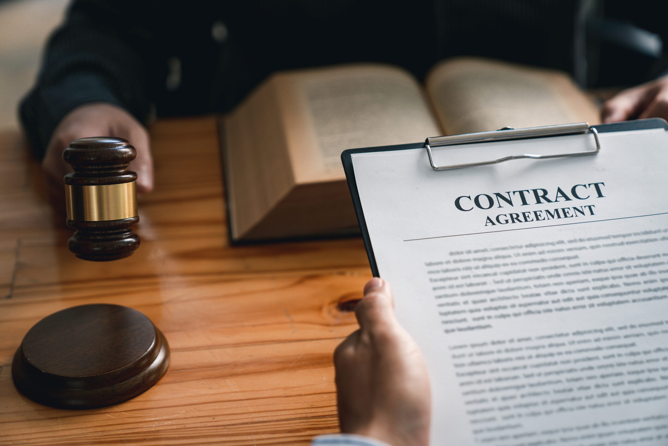 Legal counsel presents to the client a signed contract with gavel and legal law. justice and lawyer