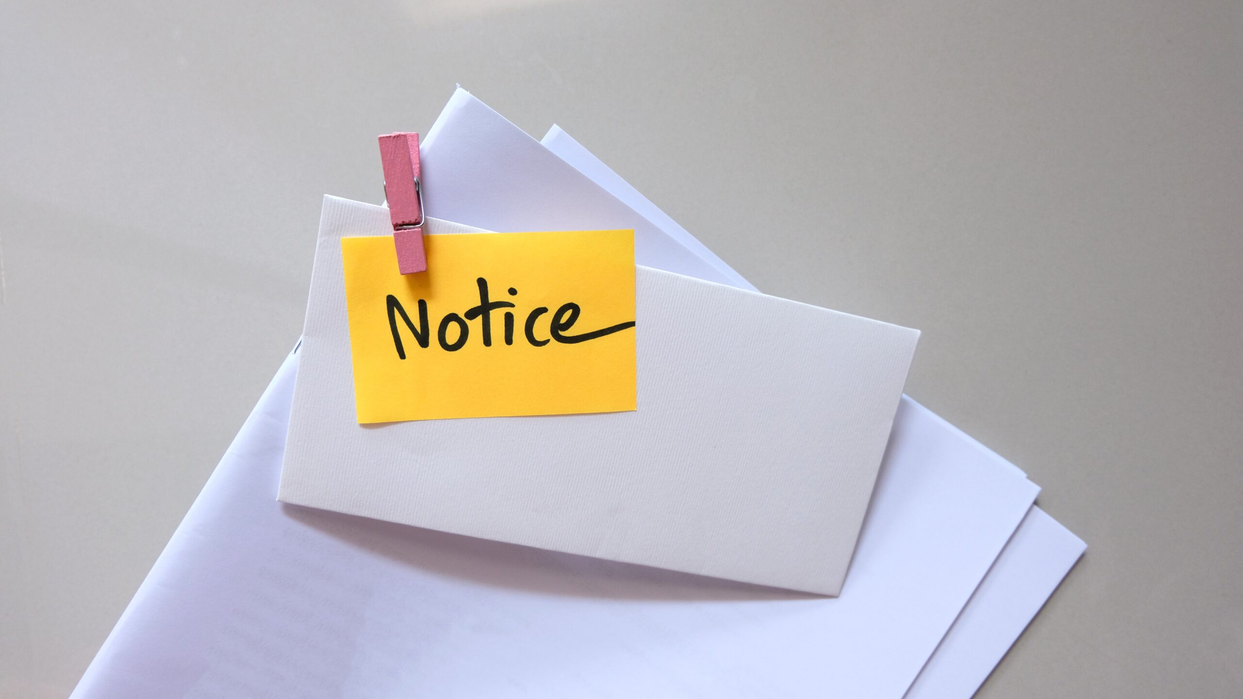 Notice message concept written post it on envelope.