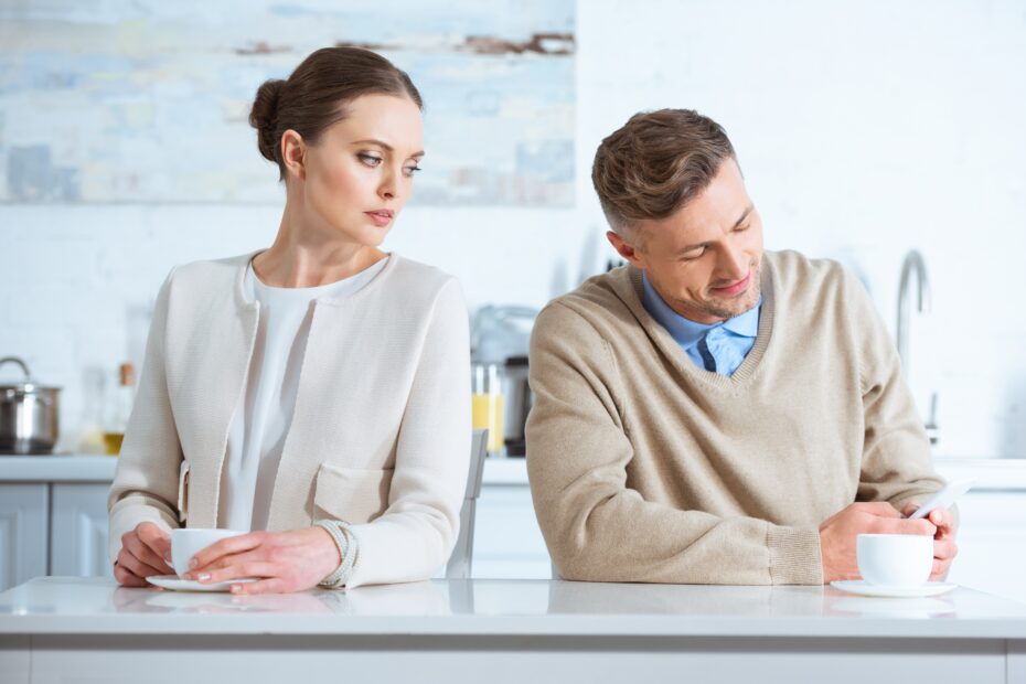 selective focus of adult man ignoring upset woman during breakfast in morning