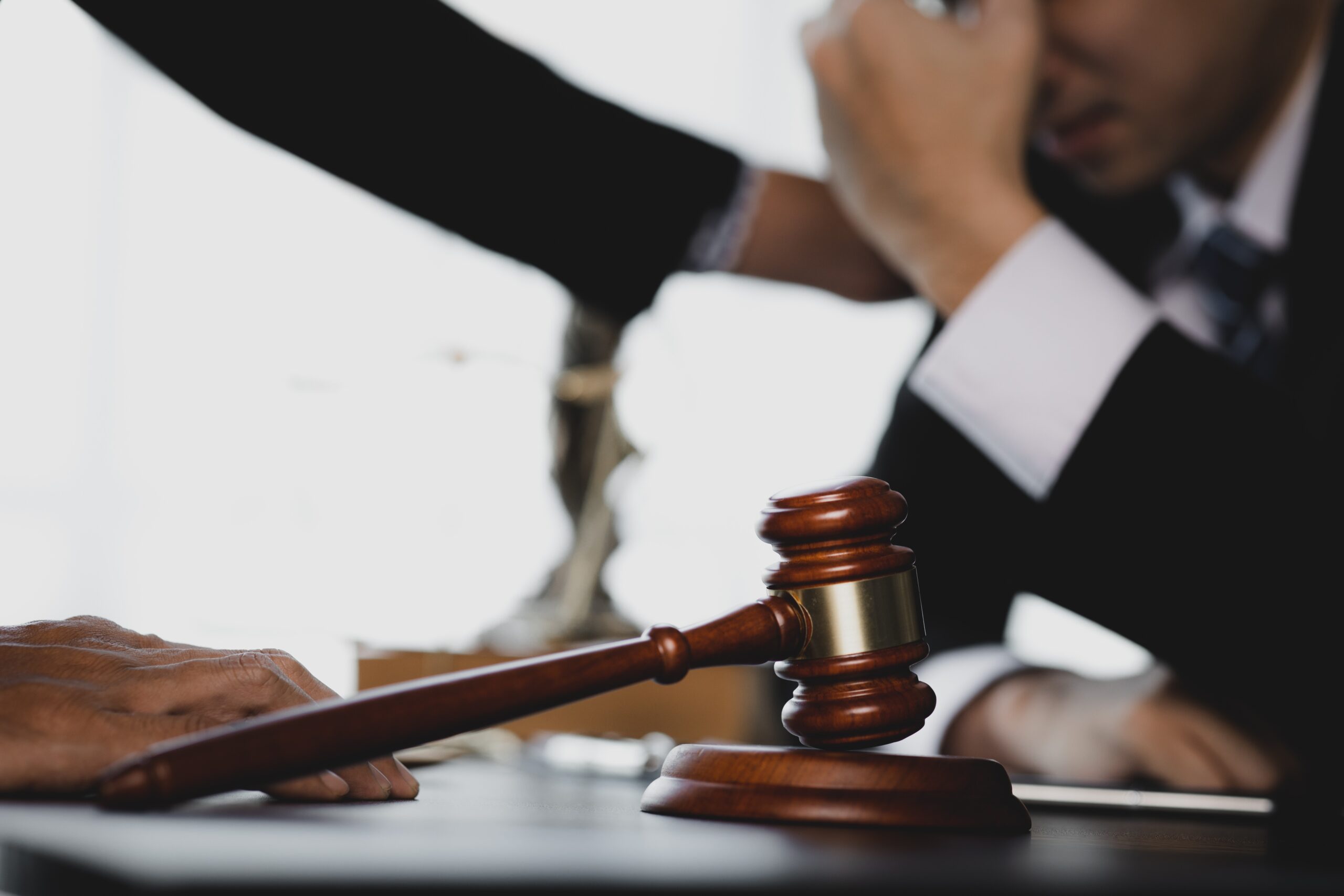 Small hammer gavel on the desk in the lawyer's room.