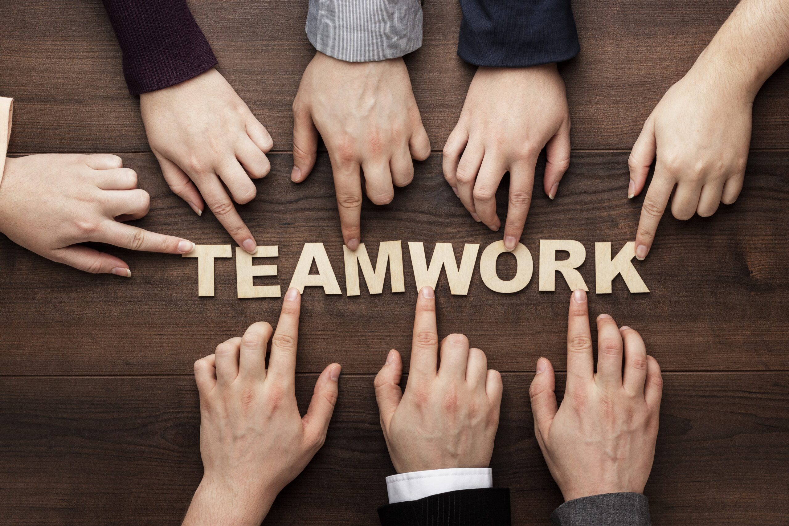 Teamwork Concept On The Brown Wooden Table Background