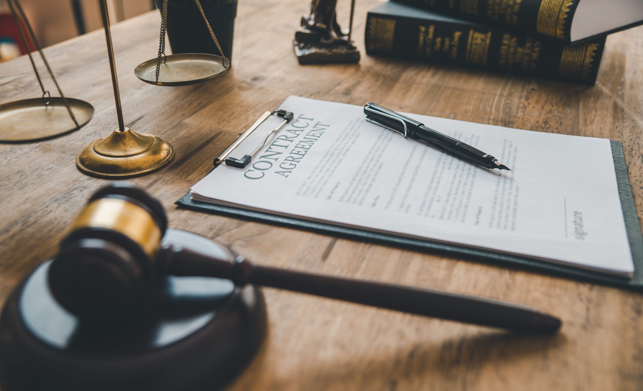 The contract agreement book is on the table, along with the judge's hammer.