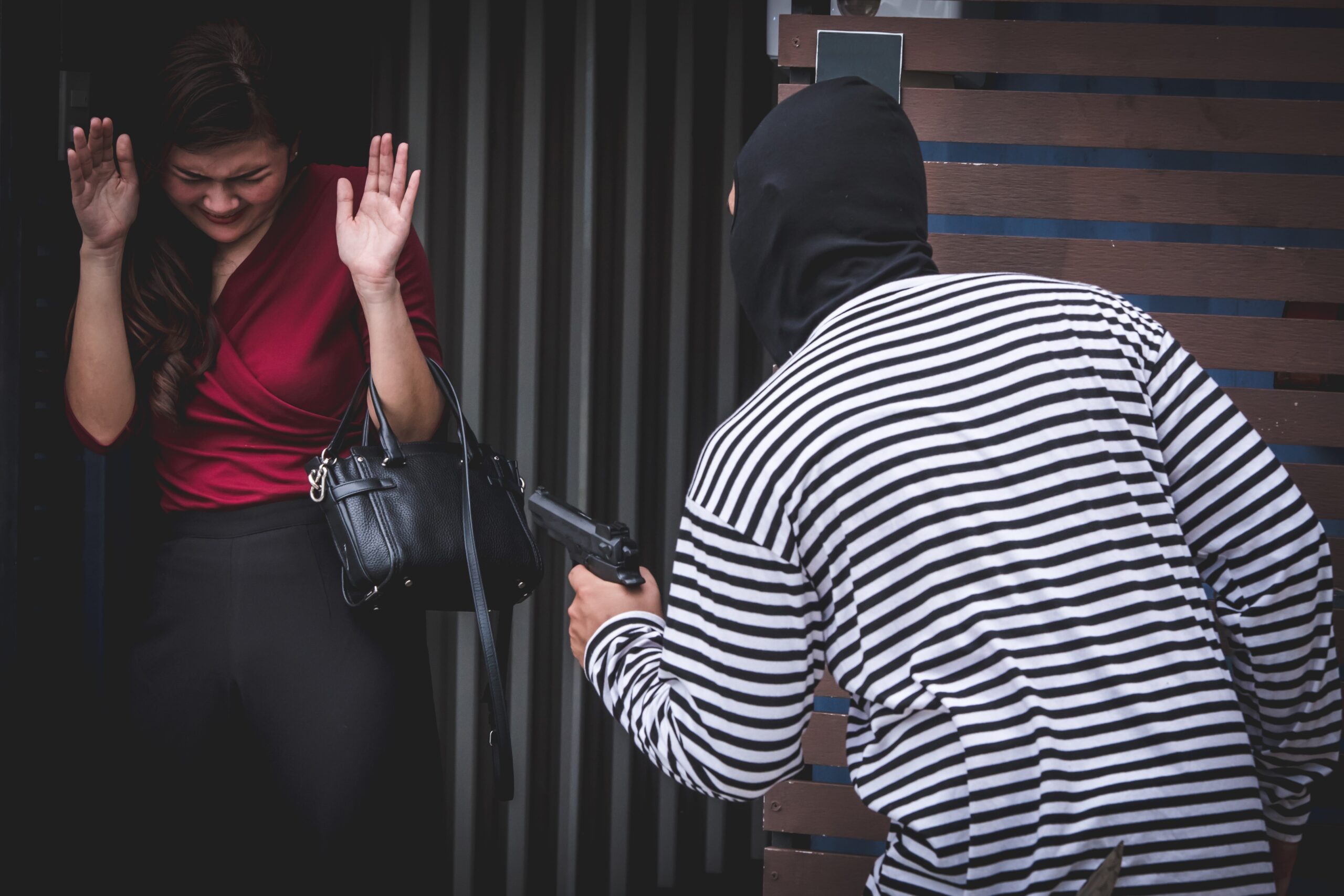 Thief is looking at an asian woman who is in a toilet alone because he want to steal her bag.