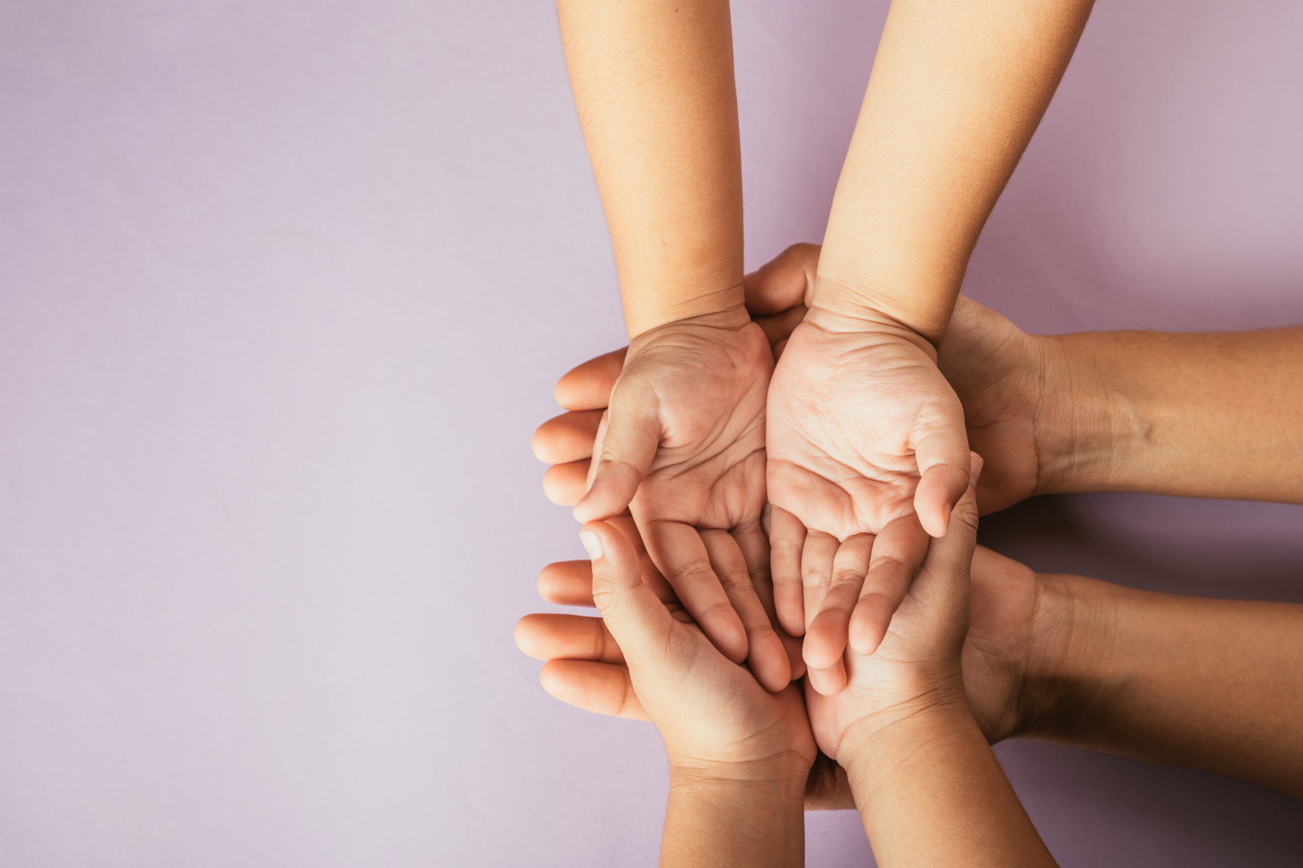 Top view of parents and kid holding empty hands on color background. Celebrating Family Day