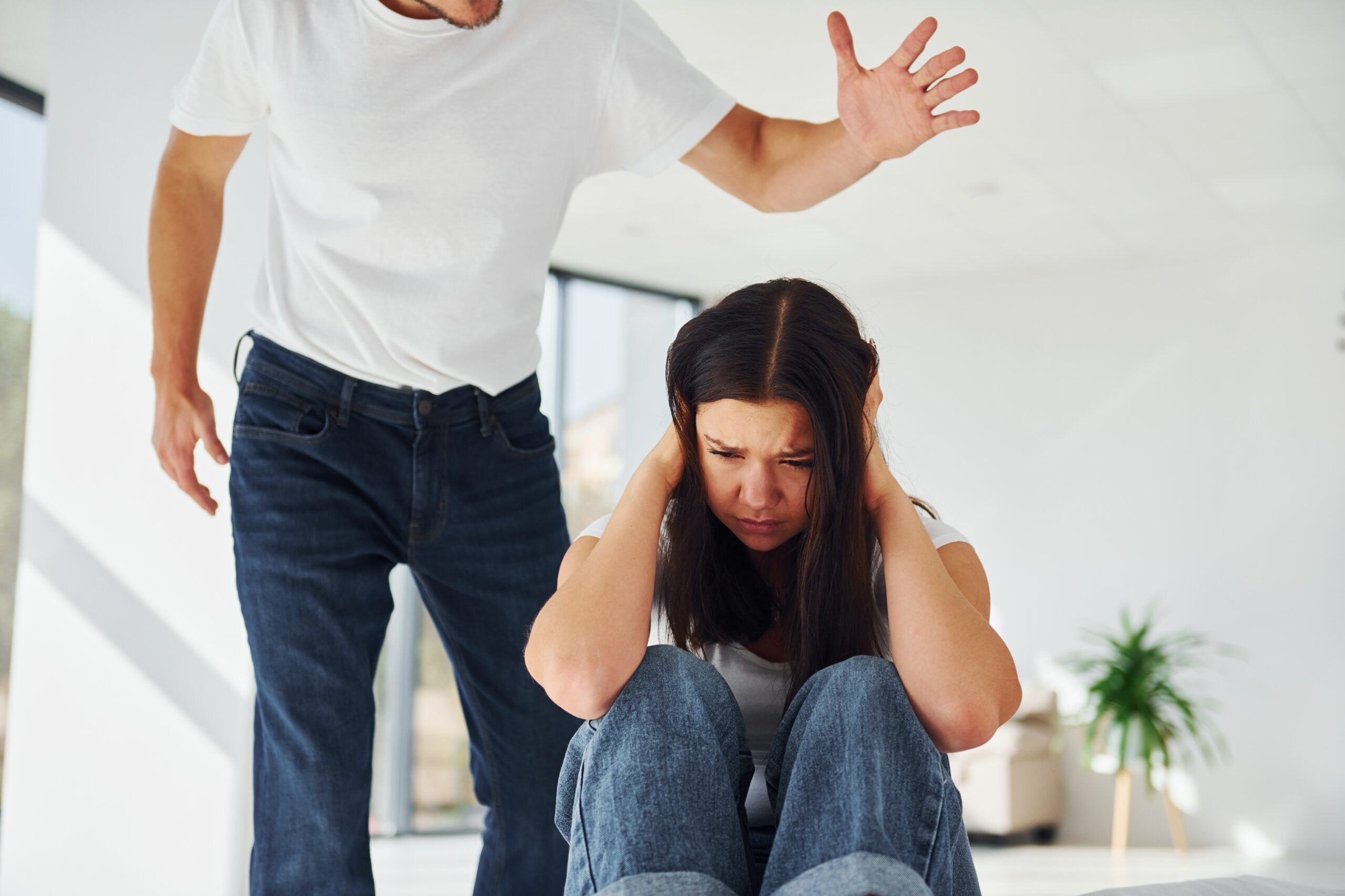 Violent aggressive young man threatening his girlfriend at home