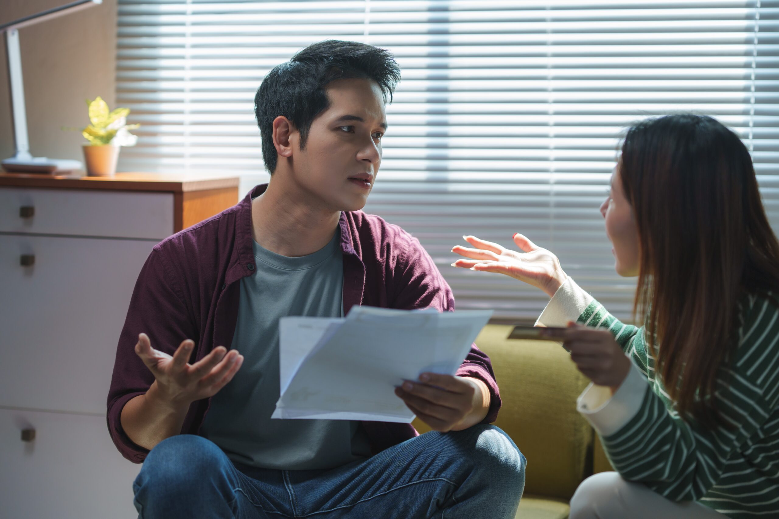 Young couple arguing about bills at home