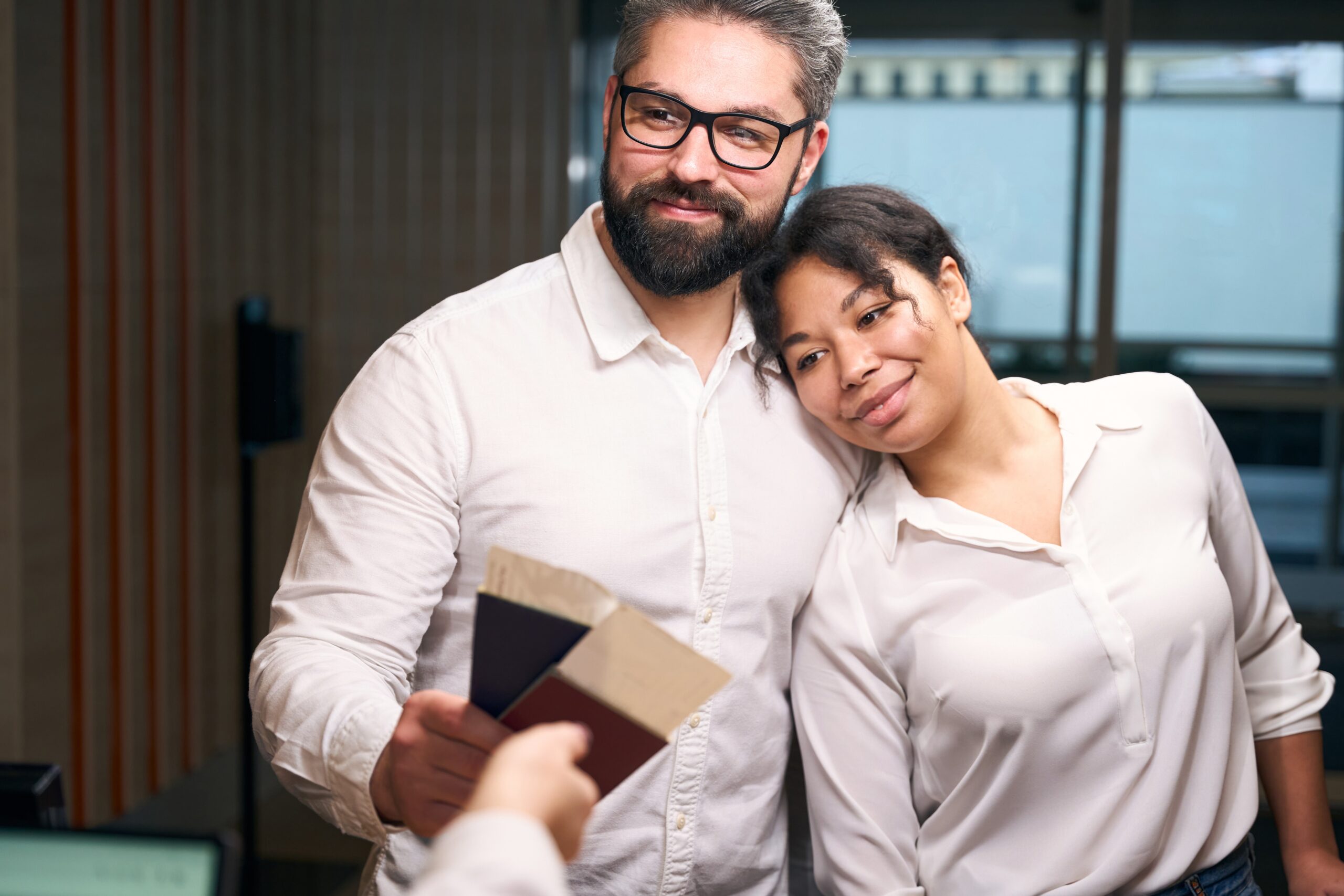 Young mixed-race romantic couple checking into hotel