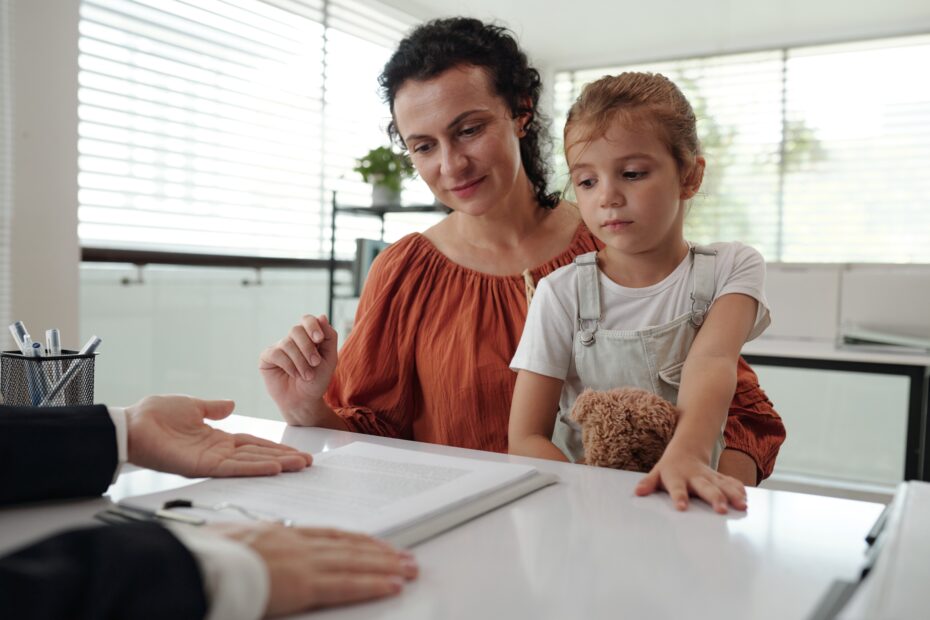 Young Mother Signing Application At Social Service