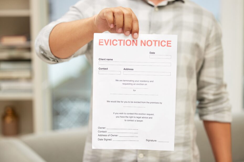 Youre outta here. Shot of an unrecognizable man holding an eviction notice.